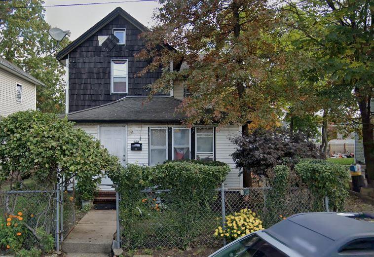 258 Covert St, Westbury, NY 11590 - view of front of home with a fenced front yard and a gate