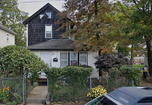 258 Covert St, Westbury, NY 11590 - view of front of home with a fenced front yard and a gate
