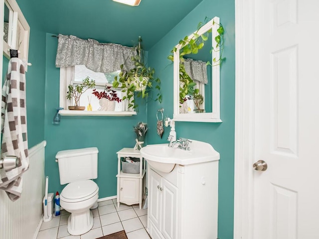 bathroom with tile patterned floors, vanity, toilet, and baseboards