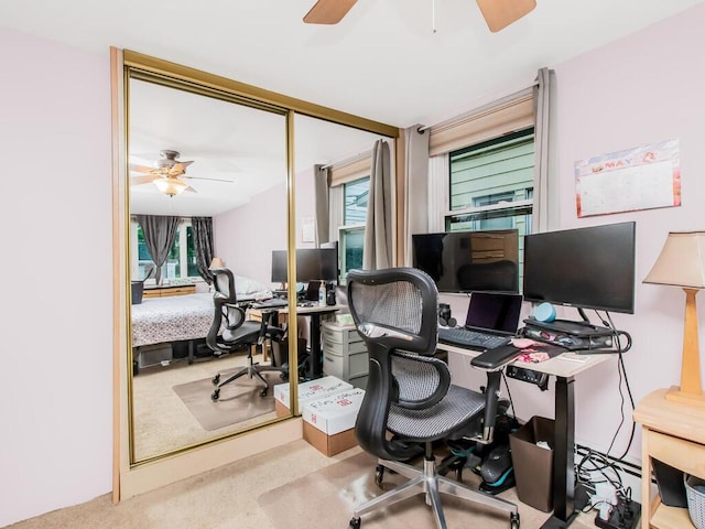 office area with a ceiling fan, healthy amount of natural light, and carpet flooring