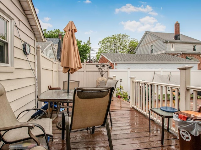 wooden deck featuring outdoor dining area and fence