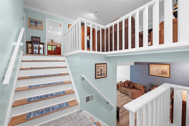 stairway featuring crown molding