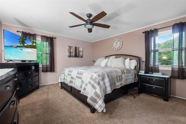 bedroom with ornamental molding, light colored carpet, baseboards, and ceiling fan