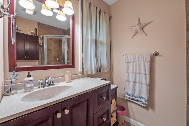 bathroom featuring a stall shower and vanity