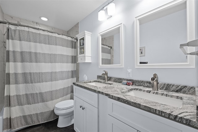 full bathroom with double vanity, toilet, and a shower with shower curtain