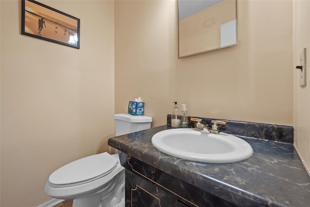 half bathroom featuring toilet and vanity