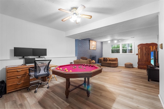 rec room featuring light wood-style floors, a fireplace, an office area, pool table, and a ceiling fan