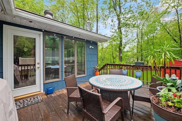 wooden terrace featuring outdoor dining space