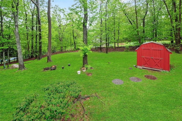 view of grassy yard with a storage unit and an outbuilding