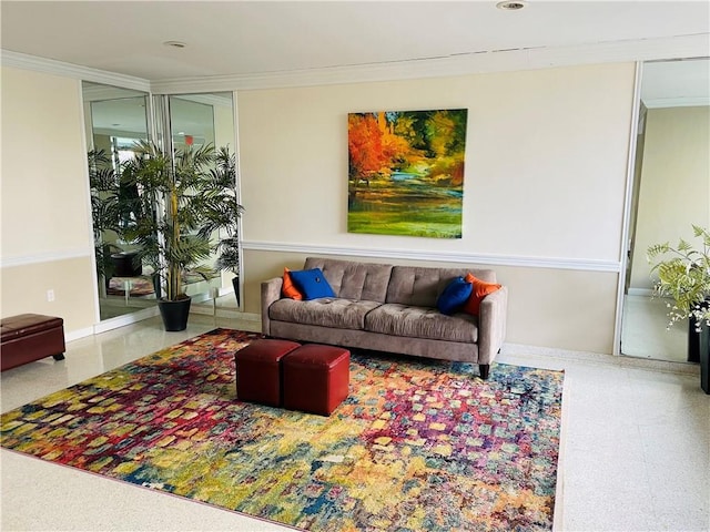 living area featuring crown molding and baseboards