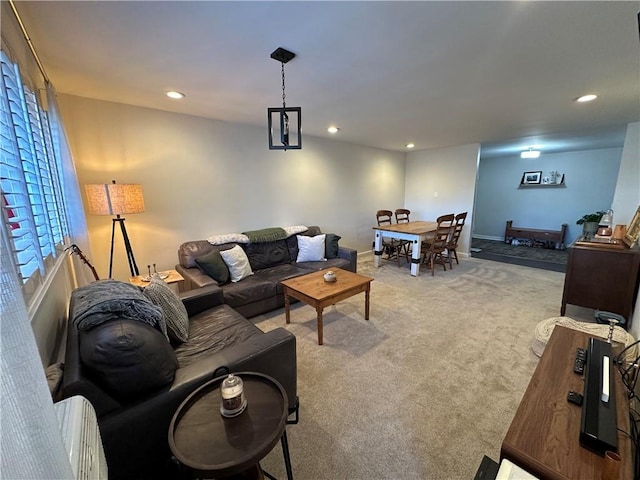 living area with light carpet, recessed lighting, and baseboards