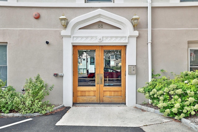 property entrance featuring french doors and stucco siding