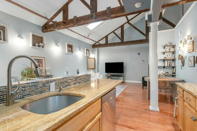 kitchen featuring stainless steel dishwasher, a sink, tasteful backsplash, light wood-type flooring, and light brown cabinets
