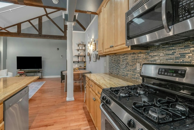 kitchen featuring appliances with stainless steel finishes, light brown cabinetry, backsplash, light wood-style floors, and baseboards