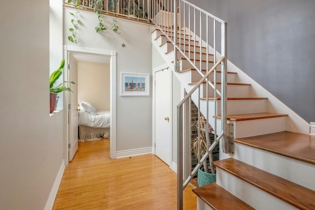 stairway featuring wood finished floors and baseboards