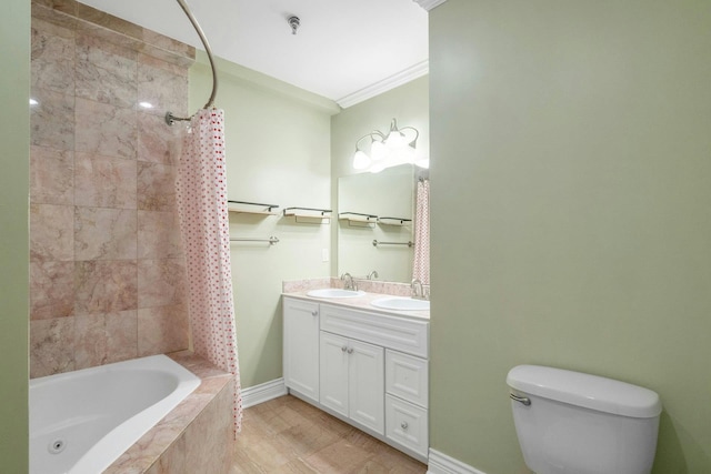 full bathroom with toilet, double vanity, crown molding, tiled shower / bath, and baseboards