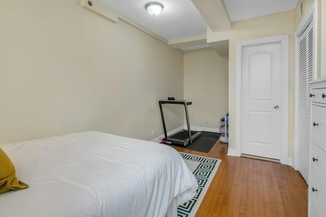 bedroom with wood finished floors and baseboards