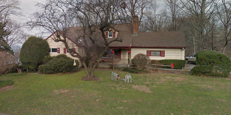 view of front of property with a chimney and a front lawn
