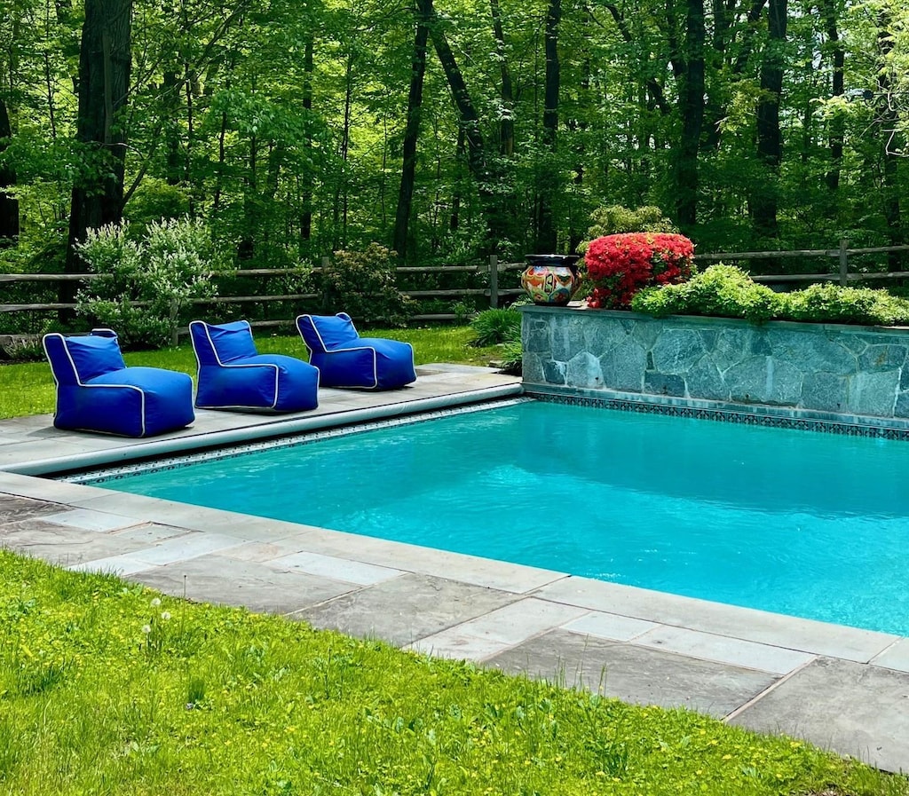 outdoor pool with a fenced backyard
