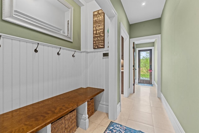 mudroom featuring light tile patterned floors and wainscoting