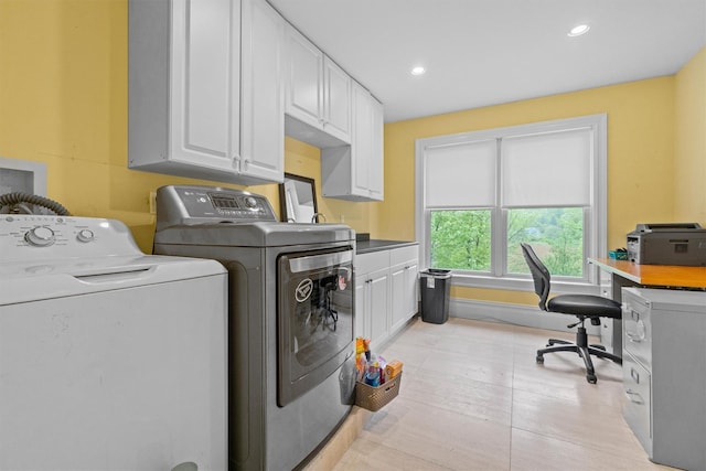 clothes washing area with washer and dryer, cabinet space, an office area, and recessed lighting