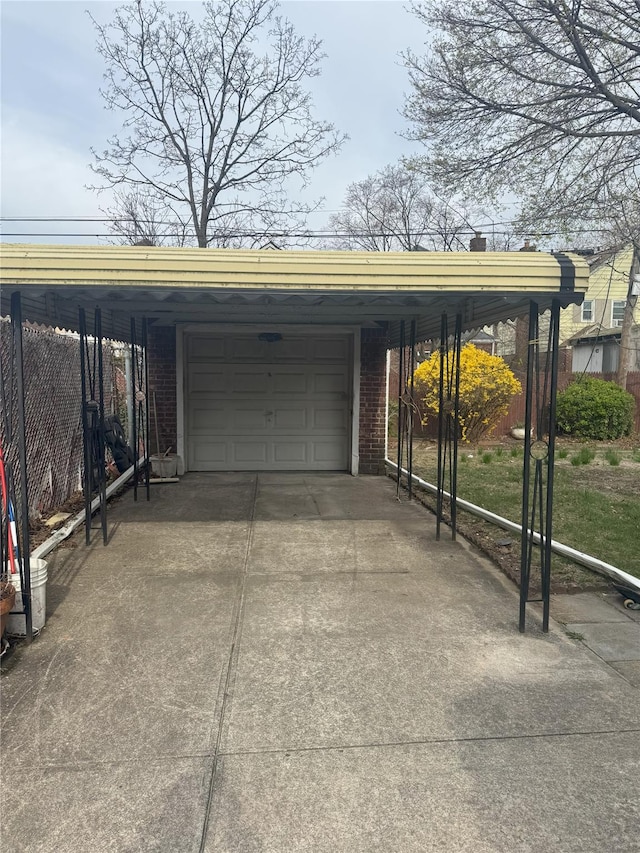11568 229th St, Cambria Heights, NY 11411 - view of parking / parking lot with driveway, fence, and an attached garage