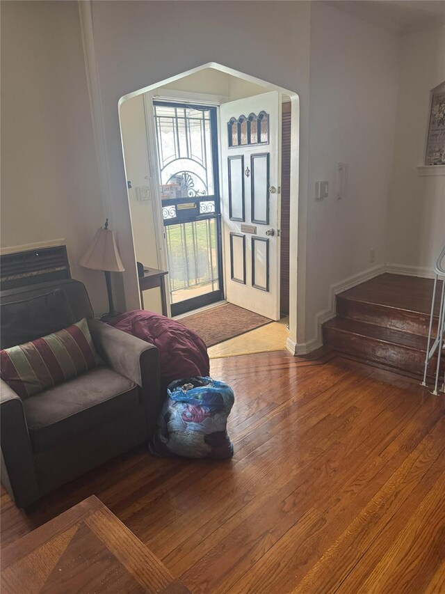 11568 229th St, Cambria Heights, NY 11411 - living area featuring wood finished floors, stairway, and baseboards
