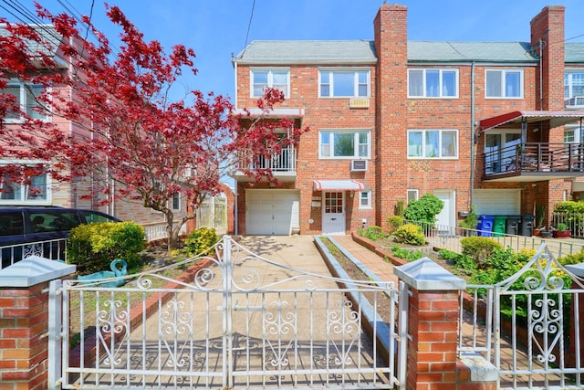 6629 74th St, Middle Village, NY 11379 - view of front of house with an attached garage, brick siding, and a fenced front yard