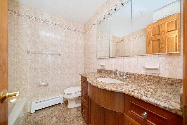 6629 74th St, Middle Village, NY 11379 - full bath with baseboard heating, tile walls, toilet, vanity, and a tub to relax in