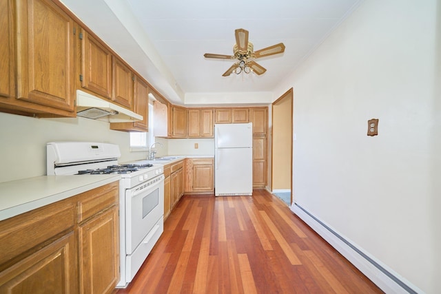 6629 74th St, Middle Village, NY 11379 - kitchen featuring white appliances, under cabinet range hood, a baseboard heating unit, a sink, and light wood finished floors