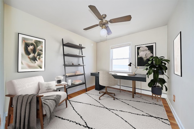 6629 74th St, Middle Village, NY 11379 - home office with wood finished floors, baseboards, and a ceiling fan