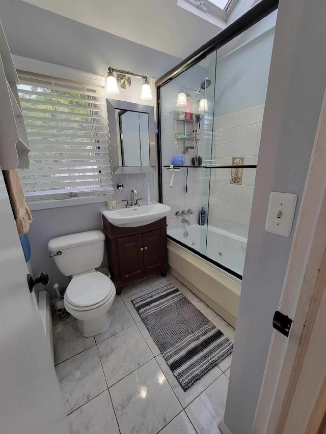 53 Bayview Ave, East Islip, NY 11730 - bathroom with toilet, vanity, enclosed tub / shower combo, and marble look tile flooring