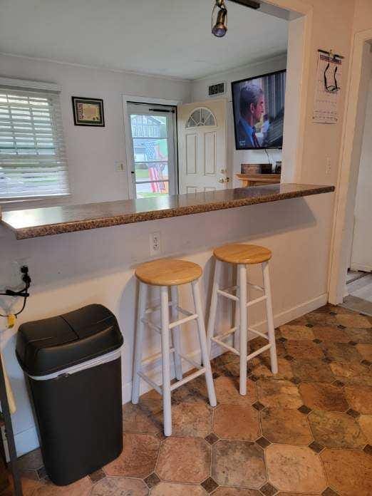 53 Bayview Ave, East Islip, NY 11730 - kitchen with plenty of natural light and a breakfast bar