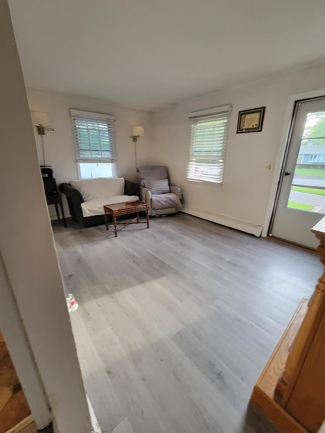 53 Bayview Ave, East Islip, NY 11730 - sitting room with healthy amount of natural light, wood finished floors, and baseboard heating