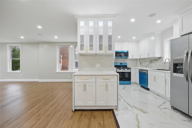 234 Quincy Ave, Bronx, NY 10465 - kitchen with appliances with stainless steel finishes, white cabinets, a sink, backsplash, and recessed lighting