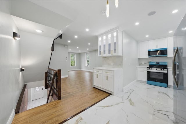 234 Quincy Ave, Bronx, NY 10465 - kitchen with stainless steel appliances, recessed lighting, white cabinets, glass insert cabinets, and baseboards