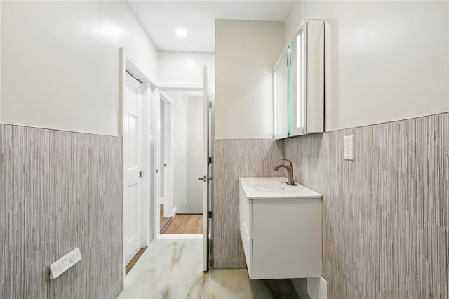 234 Quincy Ave, Bronx, NY 10465 - bathroom featuring vanity, wainscoting, and tile walls