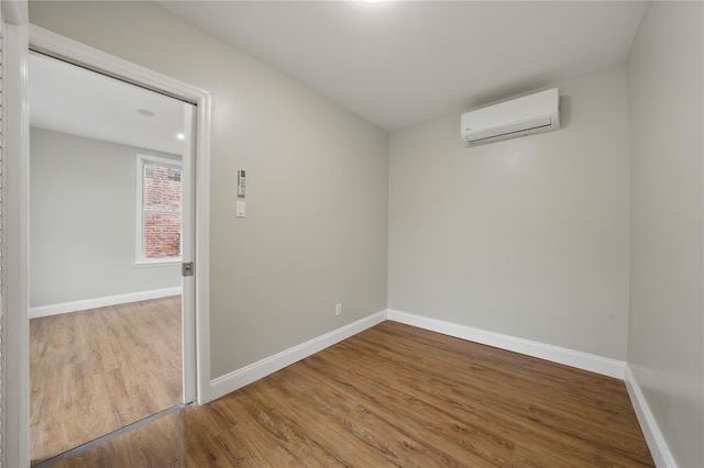234 Quincy Ave, Bronx, NY 10465 - unfurnished room featuring a wall mounted air conditioner, wood finished floors, and baseboards