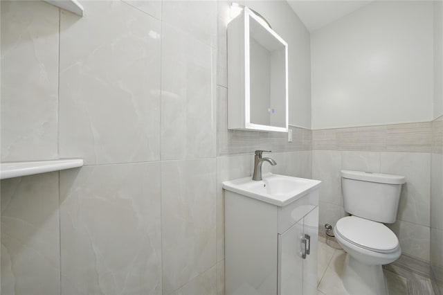 234 Quincy Ave, Bronx, NY 10465 - bathroom featuring vanity, toilet, and tile walls
