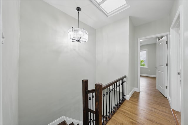 234 Quincy Ave, Bronx, NY 10465 - hall featuring an upstairs landing, baseboards, wood finished floors, and a chandelier