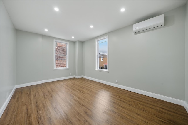 234 Quincy Ave, Bronx, NY 10465 - unfurnished room featuring a wall mounted AC, recessed lighting, wood finished floors, and baseboards