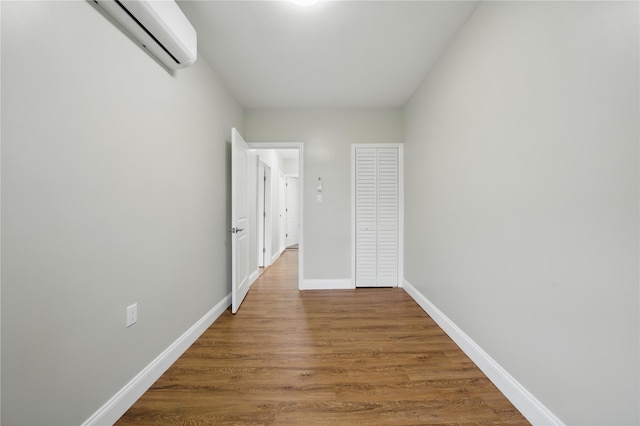 234 Quincy Ave, Bronx, NY 10465 - unfurnished bedroom featuring a wall mounted AC, wood finished floors, and baseboards