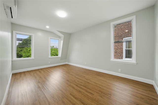 234 Quincy Ave, Bronx, NY 10465 - empty room featuring a wall unit AC, wood finished floors, and baseboards