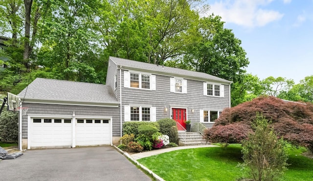 84 Lefurgy Ave, Dobbs Ferry, NY 10522 - colonial home with a garage, asphalt driveway, a shingled roof, and a front lawn