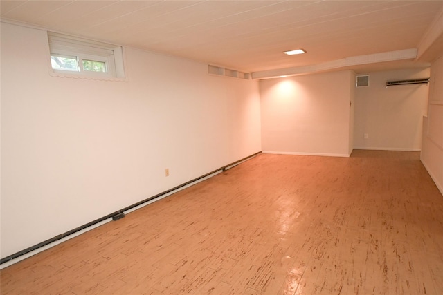 below grade area featuring light wood finished floors and baseboards