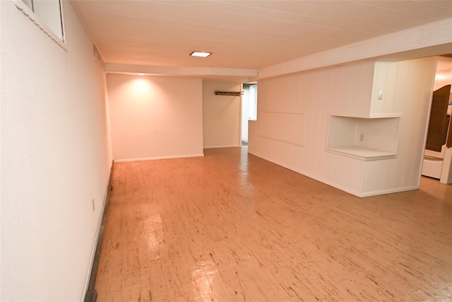 spare room featuring wood finished floors and baseboards