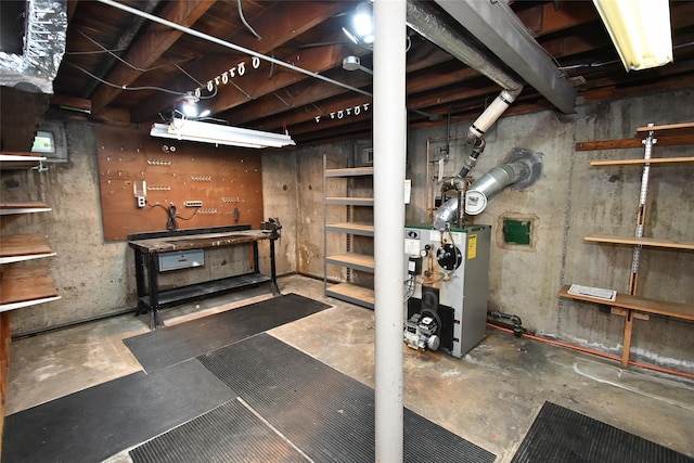 unfinished below grade area with a workshop area and a heating unit
