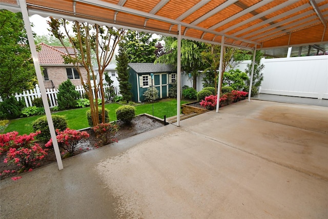 view of patio with a shed and an outbuilding
