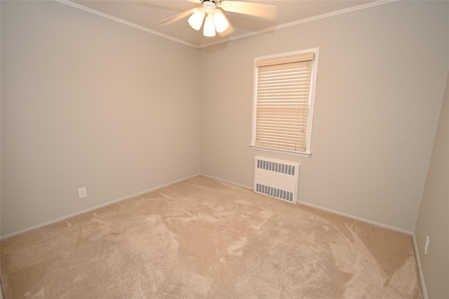 carpeted spare room featuring radiator heating unit, a ceiling fan, baseboards, and ornamental molding
