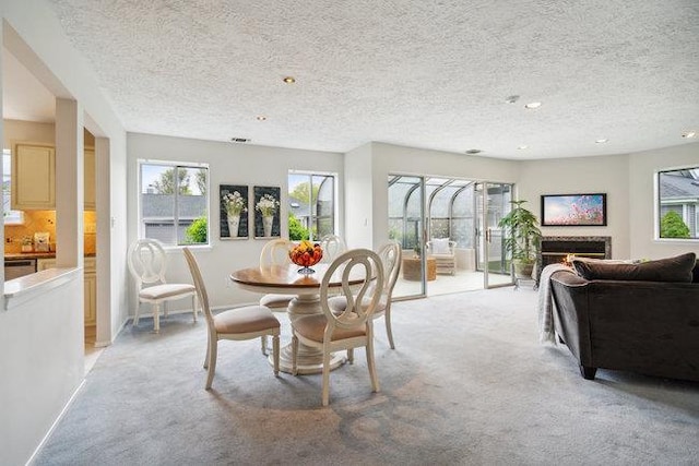 106 E Midland Pond Ct First Floor, First Floor, Moriches, NY 11955 - dining space with light colored carpet, a textured ceiling, a lit fireplace, and recessed lighting